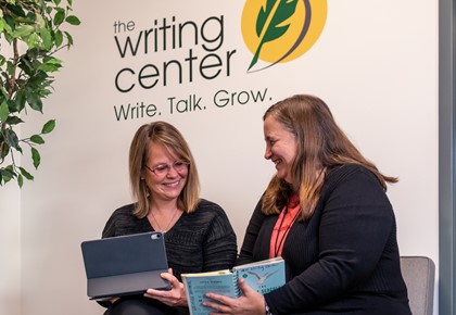 Woman talking with Sara Hansen by the Writing Center