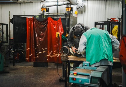 Two students welding on the Greenville campus